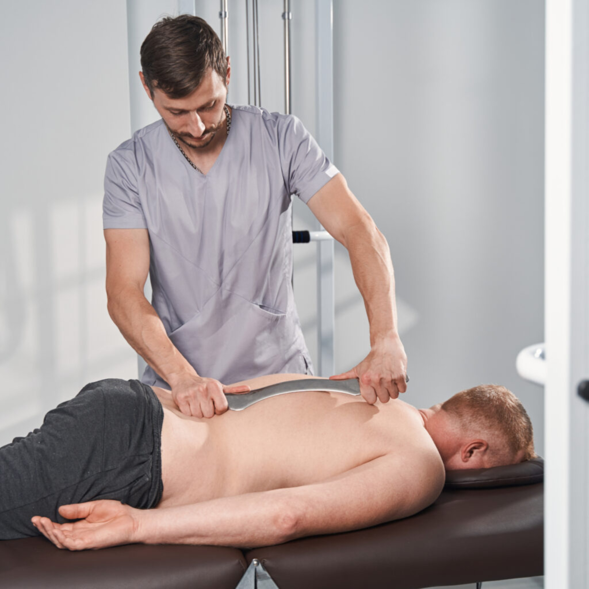 doctor-doing-deep-tissue-iastm-massage-for-man-wit-2021-11-03-15-42-52-utc